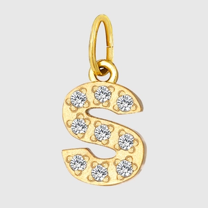 Macro shot of gold letter S pendant with clear zircon inlay and polished steel finish
