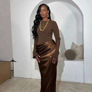 Detailed close-up of dark brown slim-fit dress featuring satin pleated waist and soft draping
