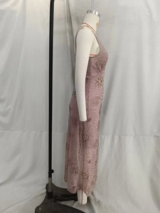 Detail of hand-sewn sequins and intricate beadwork on this pink tulle midi dress