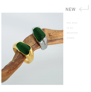 Macro view of vintage irregular stainless steel ring with rectangular green stone inlay