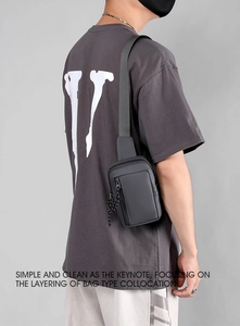 Detail view of water-resistant dark grey nylon chest bag with premium zipper pulls