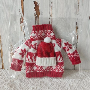 Detailed view of red and white Christmas knitted wine bottle sweater and hat in packaging