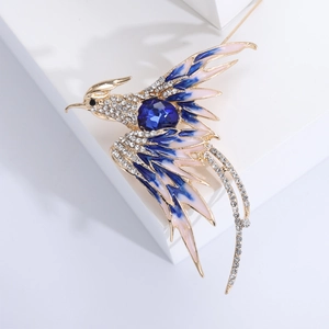 Detailed macro view of an elegant phoenix brooch with blue enamel and sparkling rhinestones