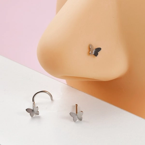 Detailed view of silver butterfly nose studs in straight and hook styles on pink background