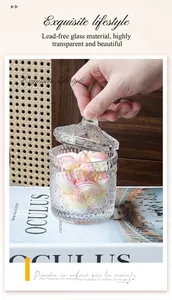 Close-up of glass candy jar with vintage embossed sunflower patterns and glass lid