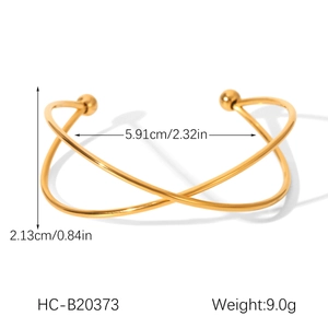 Macro shot showing dimensions and weight of a golden stainless steel crisscross bangle
