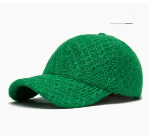 Detail of green lamb wool baseball cap showing thick textured knit and diamond pattern