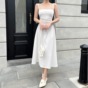 Detail of ruched waist design on a white midi sundress with elegant flowing A-line skirt
