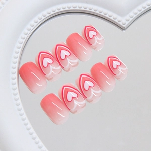 Pink gradient heart press-on nails set with sweet heart patterns on a mirror surface