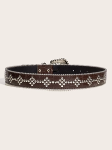 Detail of brown crocodile pattern leather belt with silver studs and vintage carved buckle
