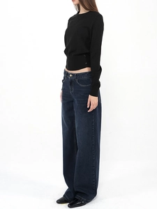 Detailed side view of black slim-fit knit sweater with decorative side button accents