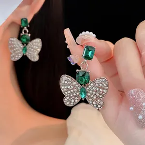 Elegant green butterfly earrings with emerald-cut stones and sparkling cubic zirconia wings