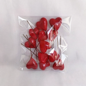 Detail of red foam heart picks for cake decoration and DIY crafts in a pack of 15 pieces