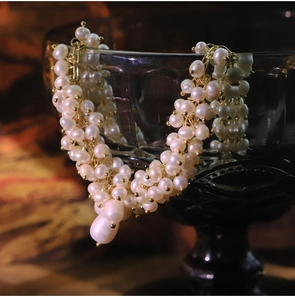 Detailed macro view of multi-strand freshwater pearl necklace with large baroque pendant