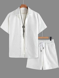 Detailed view of men's white summer set with geometric 3D textured jacquard fabric