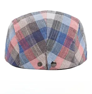 Detail view of adjustable metal buckles on plaid ivy cap for customizable head circumference
