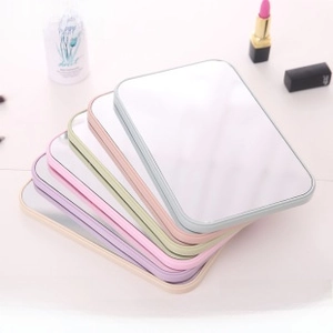 Detailed view of desktop makeup mirrors in five pastel colors with rounded edges