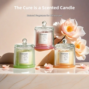 Three-piece aromatherapy candle set with glass lids and crystals on marble surface