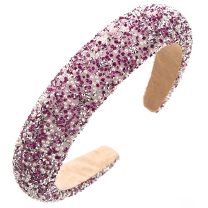 Detail of sponge headband featuring rose red rhinestones and white pearls with plush lining