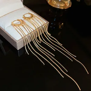 Elegant gold-plated long tassel drop earrings with heart-shaped buckle on jewelry box