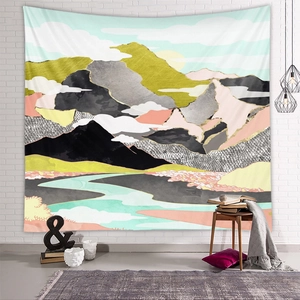 Detail of abstract mountain tapestry with gold geometric patterns in a Nordic living room