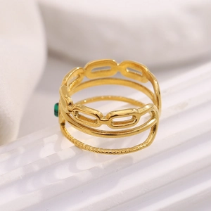 Macro detail of 18K gold-plated stainless steel layered ring with green malachite gemstone