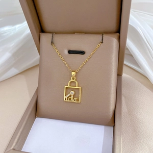 Elegant gold titanium necklace with LOVE key lock pendant and crystals in a jewelry box