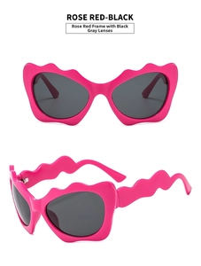 Detail view of wave-shaped rose red frames with grey lenses in Y2K cat eye style
