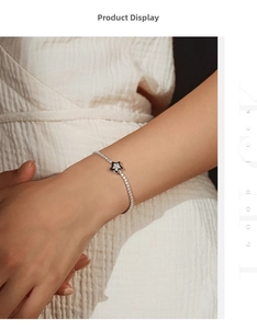 Detailed view of S925 silver bracelet with black enamel star and micro-paved diamonds