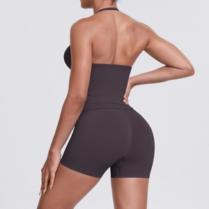 Detail of high-waist yoga shorts and halter top showing seamless dark brown fabric
