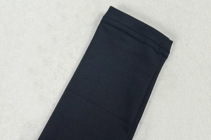 Détail d'une combinaison noire élastique montrant les coutures plates à double aiguille