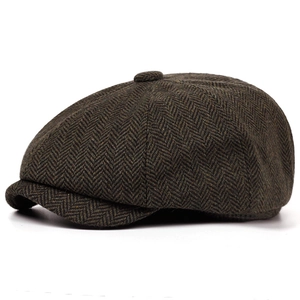 Detail of classic herringbone texture on wool blend newsboy cap in olive and brown