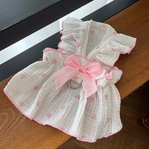Detail of pink heart pet dress with lace ruffles, bow decoration, and metal D-ring attachment