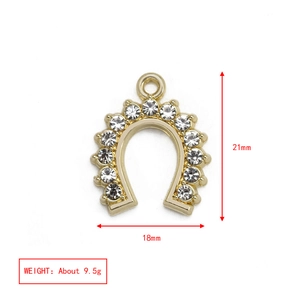 Detail view of a horseshoe charm with rhinestones showing dimensions 21mm by 18mm