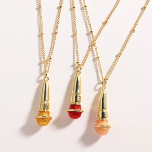 Detailed view of punk hip hop microphone pendants in gold, red, and pink enamel on bead chains