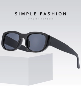 Close-up of retro black rectangular sunglasses with thick frames and grey lenses