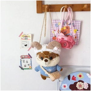 Detail of cute stuffed squirrel crossbody bag with bunny ears, glasses and gold chain