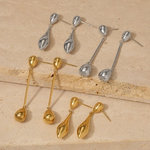 Elegant gold and silver long water drop earrings set on premium stone pedestal