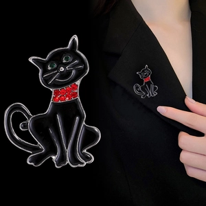 Halloween black cat brooch with red and green gemstones on suit jacket lapel