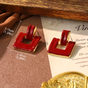 Detail view of red enamel geometric earrings with specific dimensions and weight markings