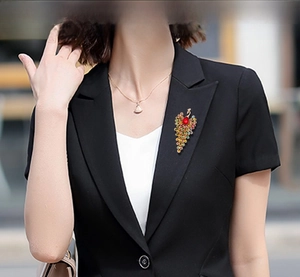 Peacock brooch with colorful rhinestones on a black suit lapel, vintage style fashion accessory