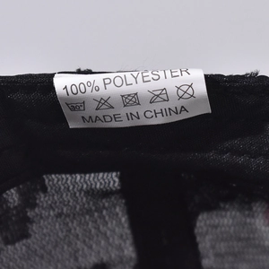 Detail shot of the care label showing 100% polyester fabric and washing instructions