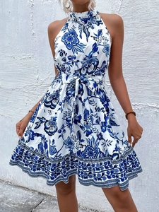 Detail of blue floral halter neck dress with waist belt and ruffled hemline