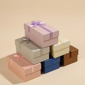Detailed stack of multi-colored rectangular gift boxes with elegant ribbon bow knots