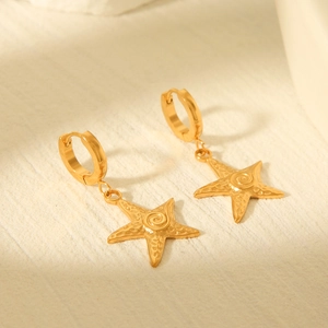 French retro 18k gold starfish hoop earrings with textured metal finish on white stone