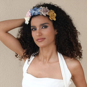 Detail of handmade fabric floral headband with colorful blossoms on a female model