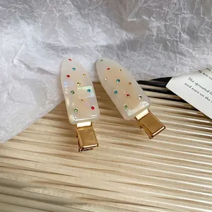 Minimalist acrylic hair clip set with multicolor rhinestones on cream resin base