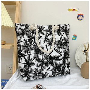 Detail of tropical palm tree print canvas tote bag with thick woven rope handles
