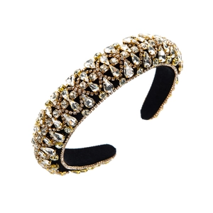 Close-up of Baroque wide headband featuring clear crystals with gold claw settings