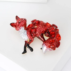 Elegant fox brooch with red gemstones and enamel finish on a clean white background